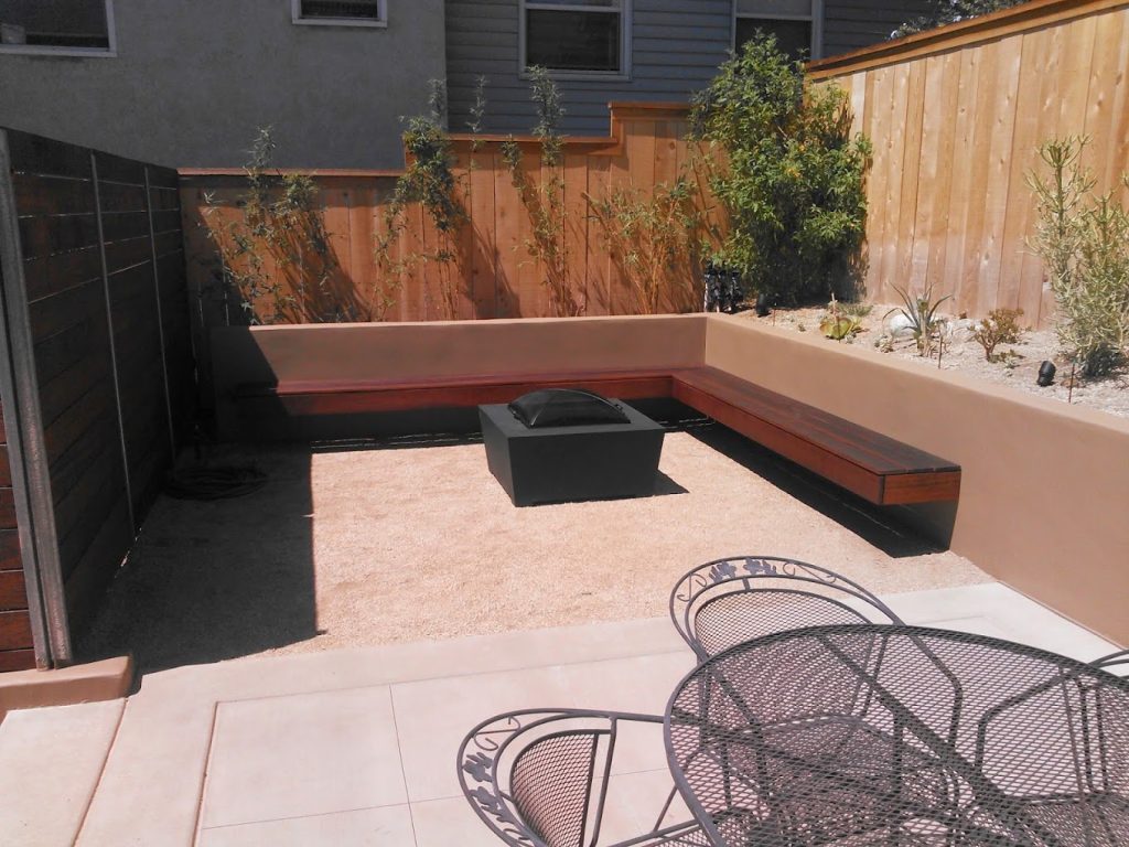 renovated outdoor space with new outdoor walls, seat walls, and fire pit